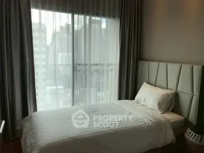 Cozy bedroom with city view and elegant decor in modern apartment.