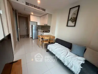 Modern living room with open kitchen, sleek furniture, and stylish decor in a contemporary apartment.