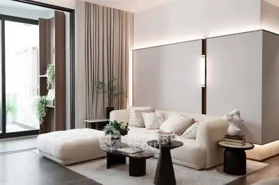 Luxurious modern living room with elegant decor and large windows for natural light.