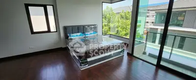 Spacious bedroom with large windows and modern design in a luxury home.