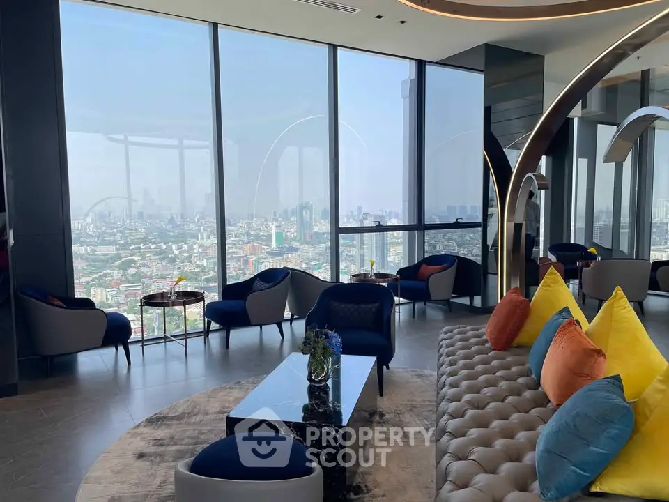 Luxurious high-rise living room with panoramic city views and modern decor.
