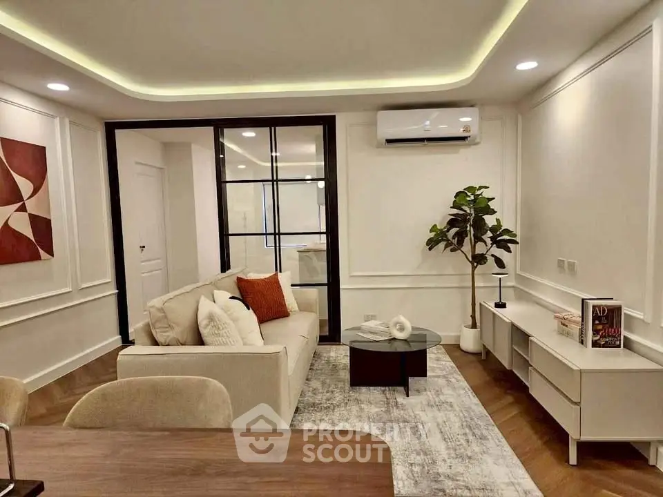 Modern living room with elegant decor and stylish furniture, featuring a cozy sofa and chic lighting.