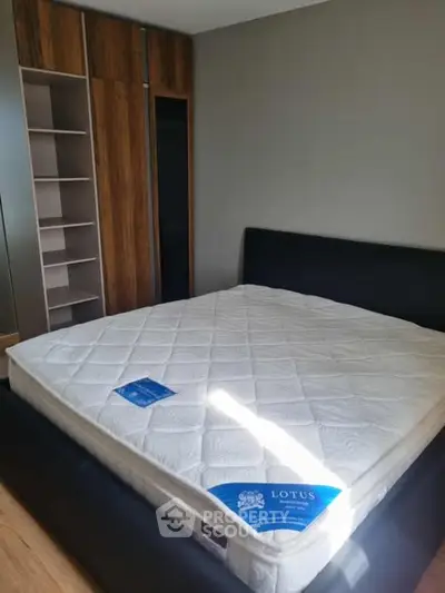 Spacious bedroom with modern bed and built-in wardrobe