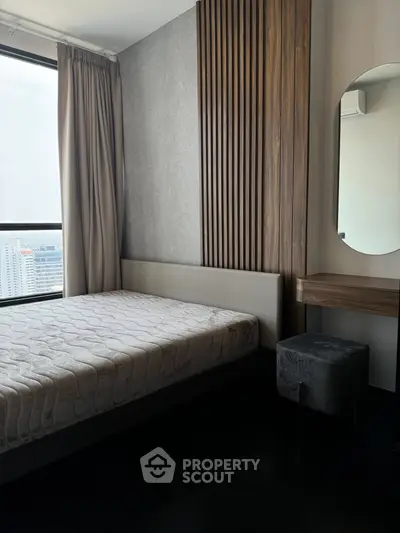 Modern bedroom with stylish wood paneling and large window view.