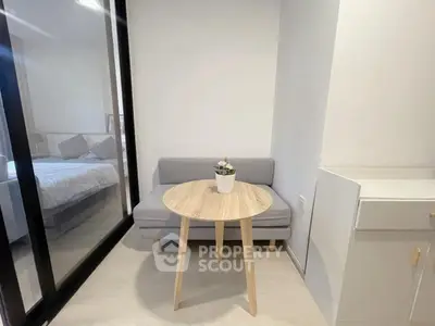 Cozy small living area with modern furniture and glass partition