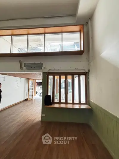Spacious interior with high ceilings and large windows, perfect for natural light and open living.