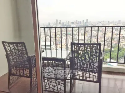 Stunning cityscape view from a high-rise balcony with stylish outdoor seating.