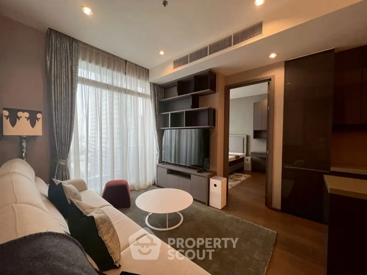 Modern living room with stylish decor and large window in a luxury apartment.