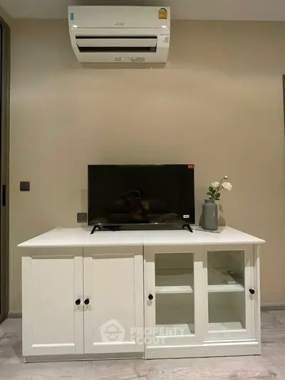 Modern living room with air conditioner and stylish TV cabinet
