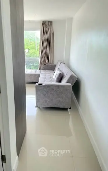 Modern living room with sleek sofa and large window view