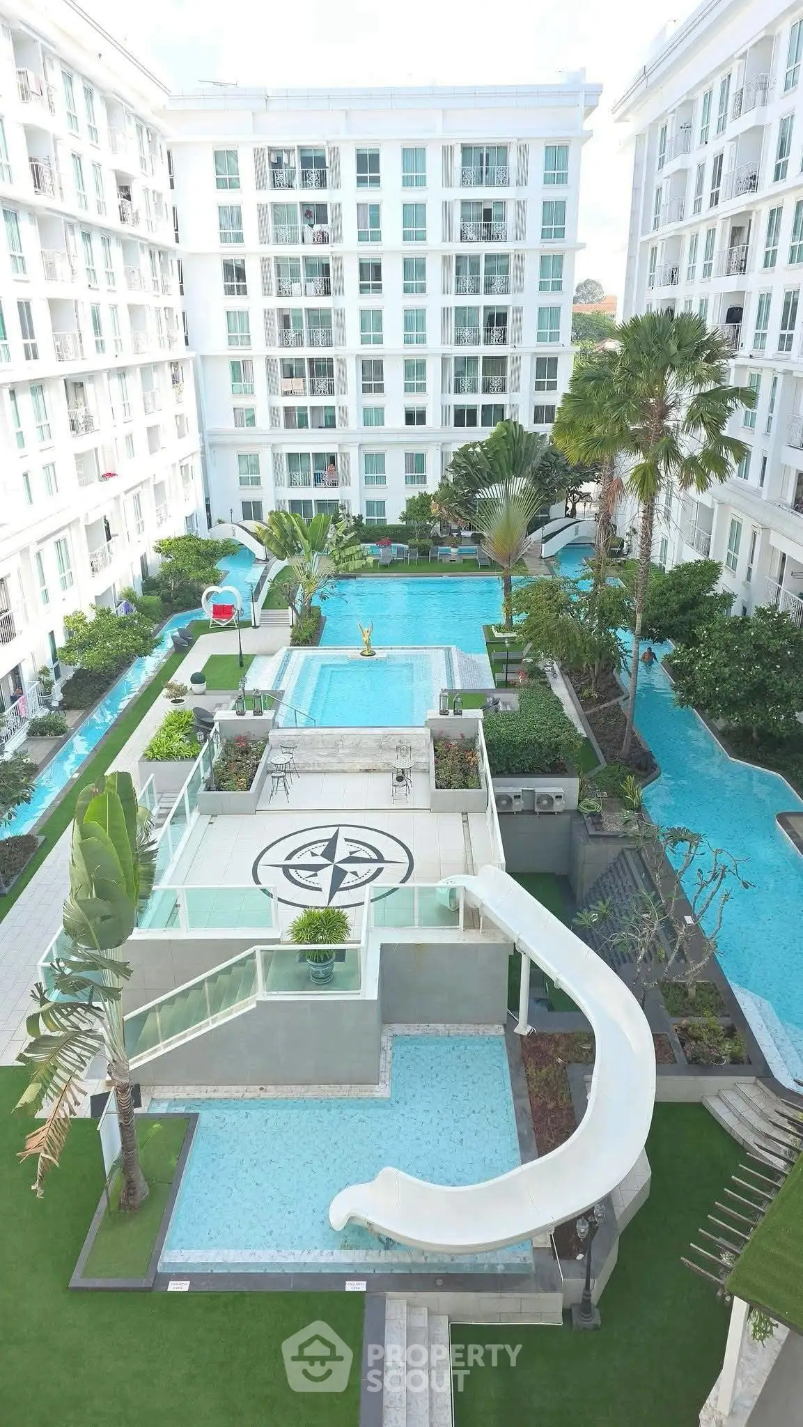 Luxurious residential complex with stunning pool and lush gardens