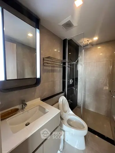 Modern bathroom with sleek fixtures and glass shower enclosure