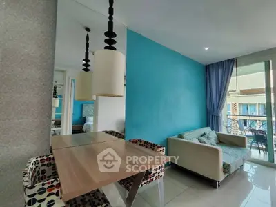 Modern living room with vibrant blue accent wall and stylish furniture.