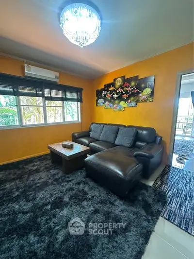 Charming living room with vibrant decor and cozy seating, perfect for relaxation and entertaining.