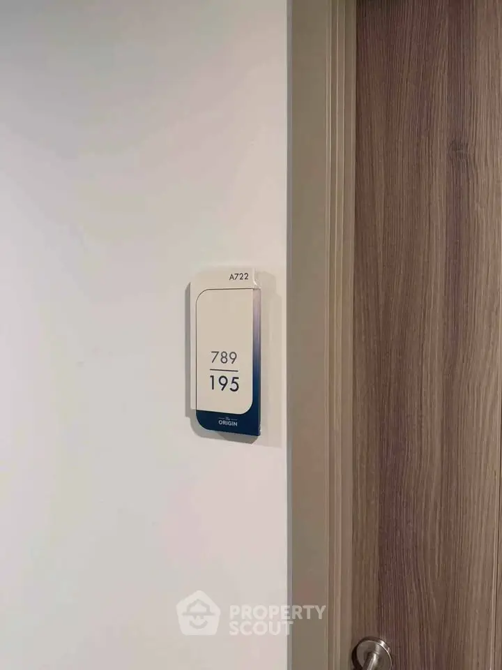 Modern apartment door with room number signage in sleek design.