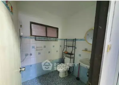 Cozy bathroom with blue tile accents and modern fixtures