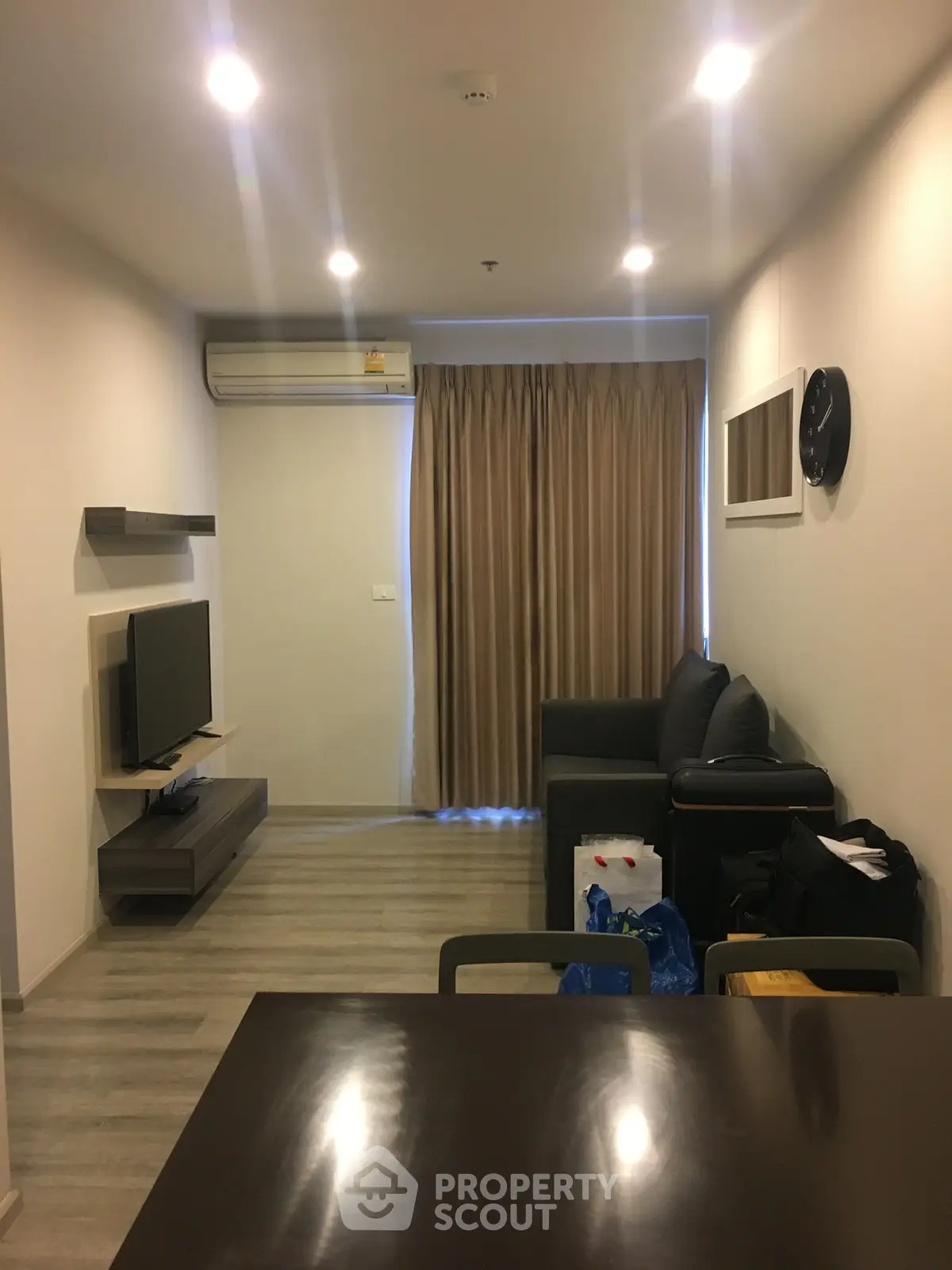 Modern living room with sleek furniture and ambient lighting, perfect for cozy evenings.