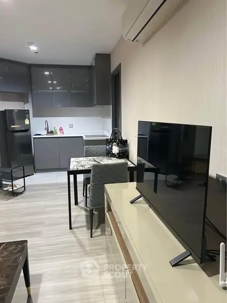 Modern open-plan kitchen and living area with sleek furniture and appliances.
