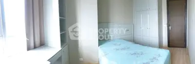 Bright bedroom with large window and built-in storage, featuring a cozy bed and modern design.