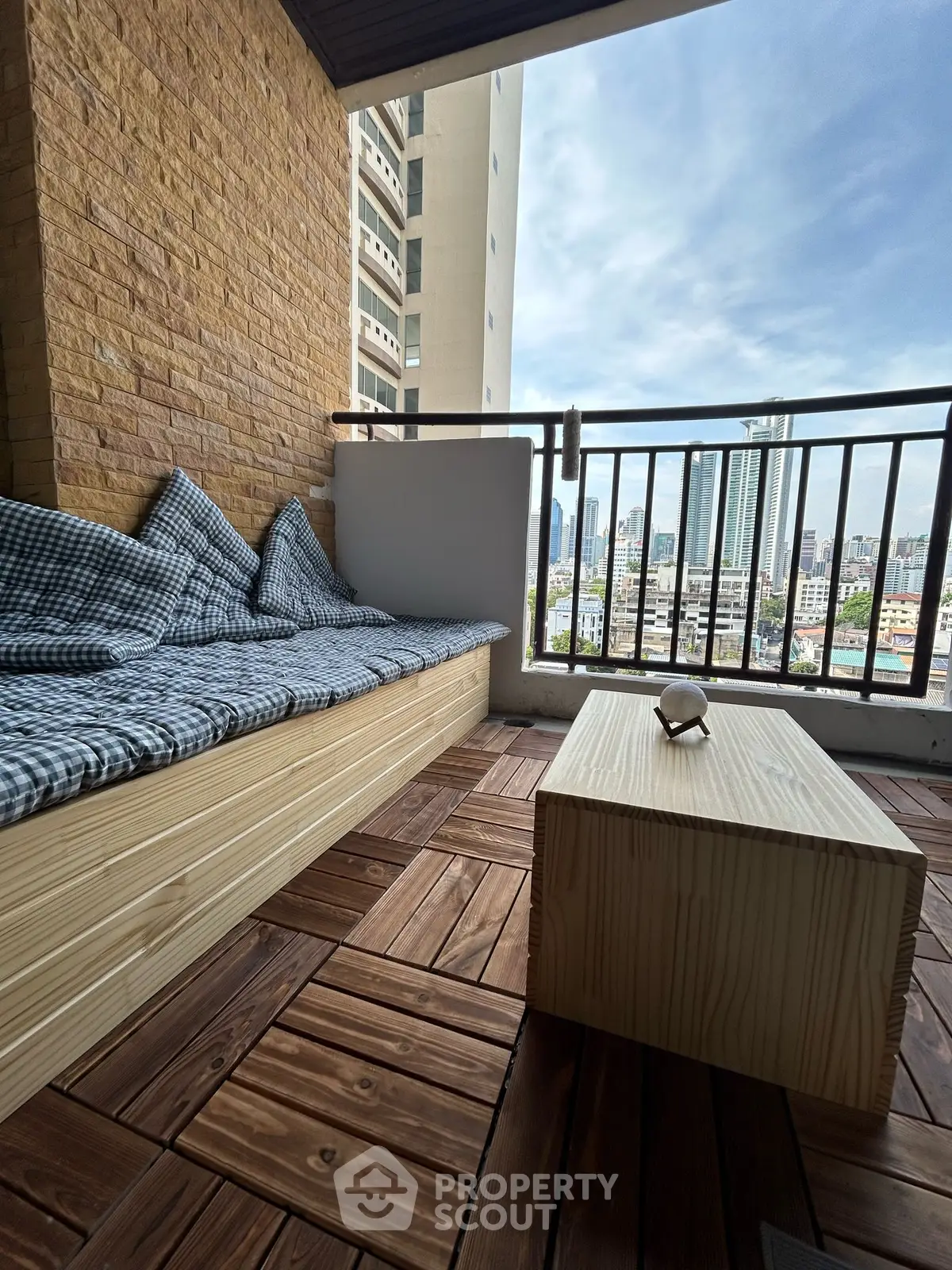 Charming balcony with cozy seating and city view, perfect for relaxation and enjoying the skyline.