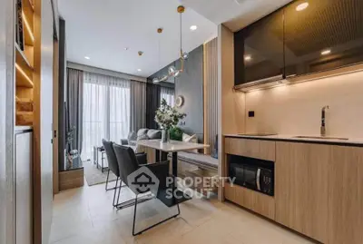 Modern open-layout kitchen and dining area with elegant decor and natural light.