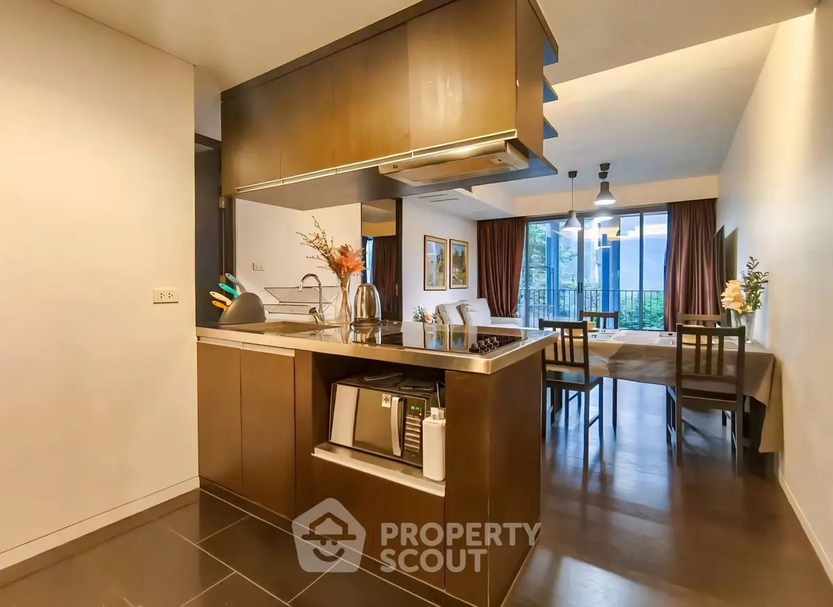 Modern open-layout kitchen and dining area with sleek design and natural light.