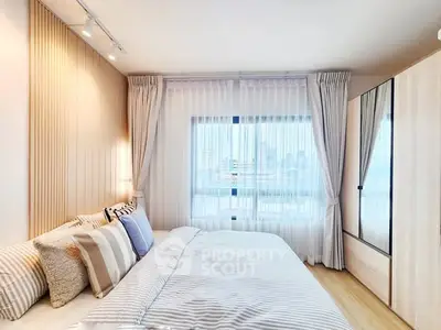 Modern bedroom with city view, featuring elegant decor and ample natural light.