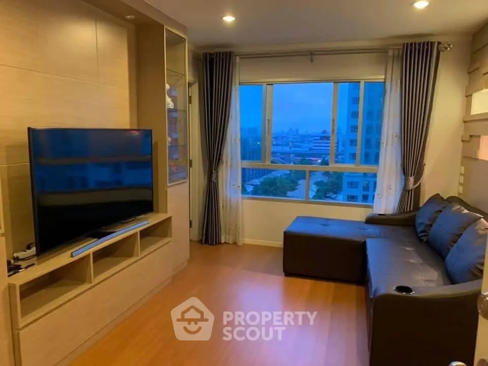 Modern living room with large TV and city view window