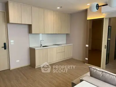 Modern kitchen with sleek cabinetry and open layout in a stylish apartment.