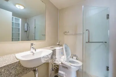 Modern bathroom with sleek fixtures and glass shower enclosure