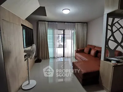 Modern living room with sleek design and natural light, featuring a stylish sofa and elegant curtains.