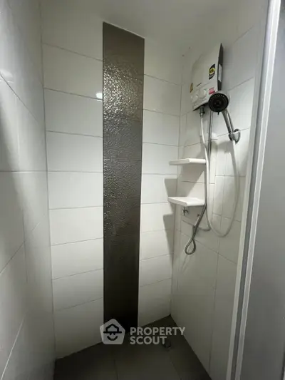 Modern bathroom shower with sleek tiles and water heater
