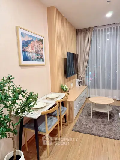 Modern living room with stylish decor, wooden flooring, and cozy dining area.
