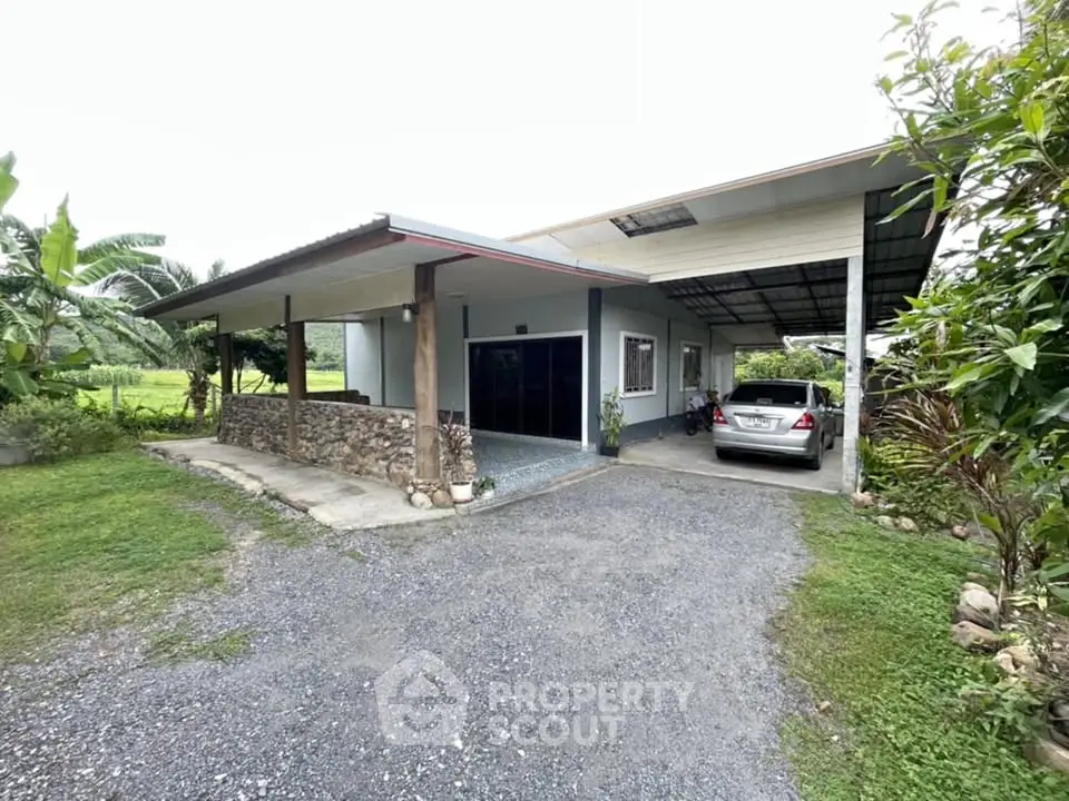 Charming countryside home with carport and lush greenery