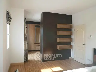 Spacious bedroom with modern wooden flooring and built-in wardrobe