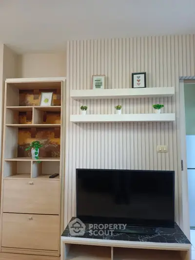 Modern living room with stylish TV setup and decorative shelving
