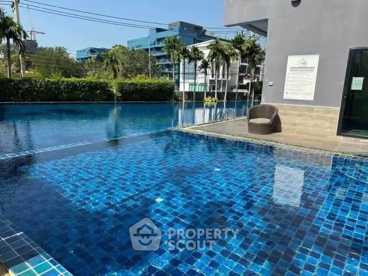 Luxurious outdoor pool with modern design and lush surroundings in prime real estate location.