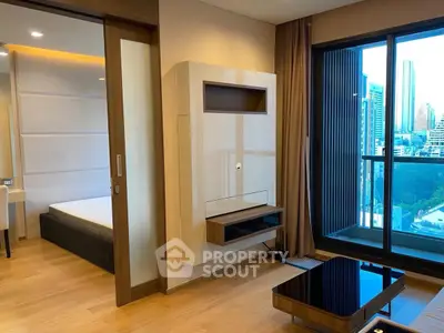 Modern apartment interior with city view, featuring a sleek living room and adjacent bedroom.