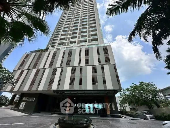 Stunning high-rise building with modern architecture and lush greenery, perfect for urban living.