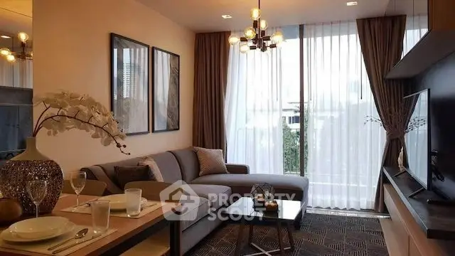 Modern living room with stylish decor, large windows, and elegant lighting in a cozy apartment.