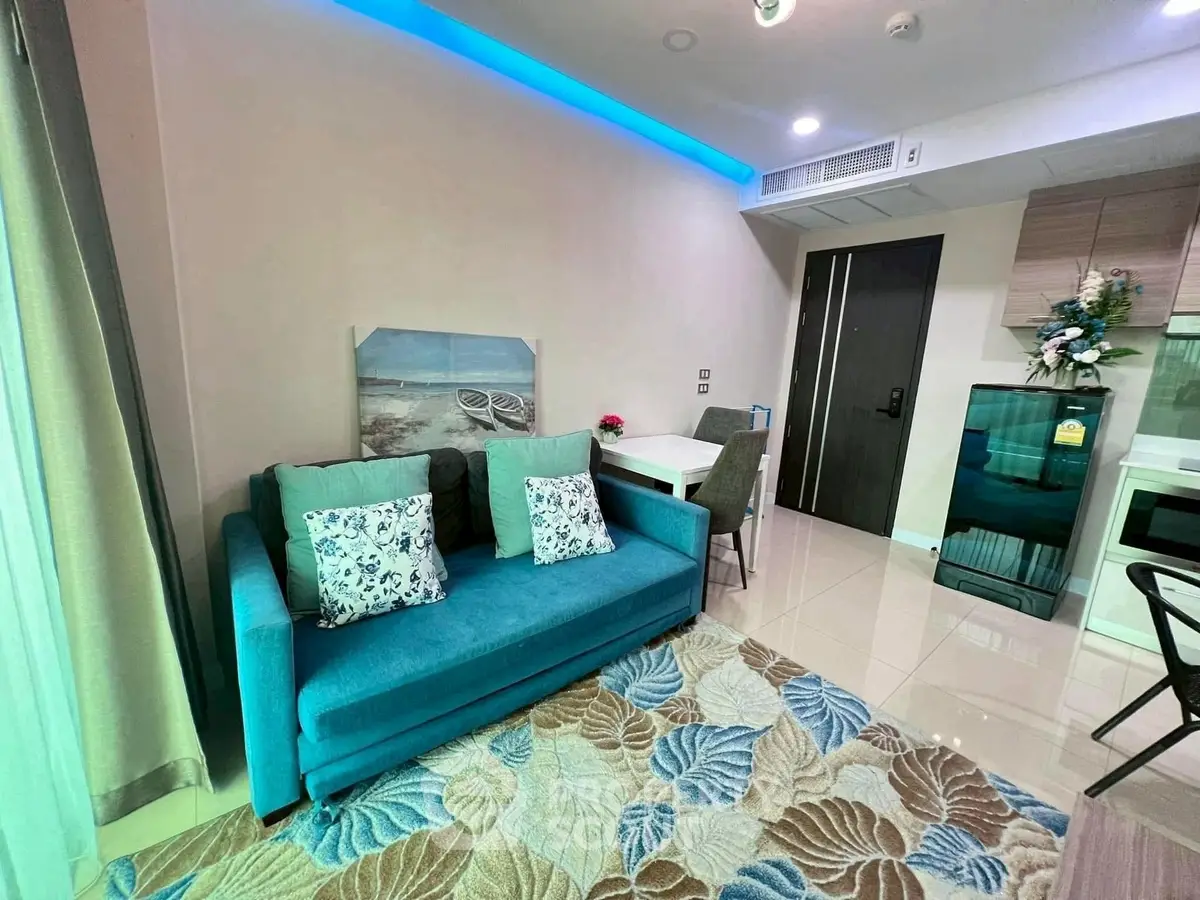Modern living room with blue sofa and stylish decor in a contemporary apartment.
