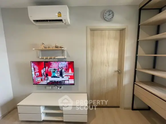 Modern living room with wall-mounted TV and air conditioning unit