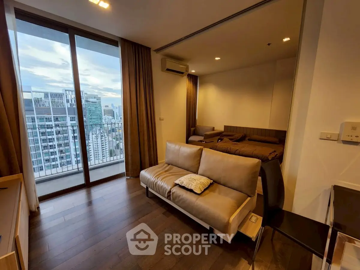 Modern studio apartment with stunning city view and cozy living area.