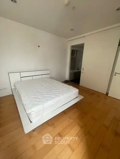 Spacious bedroom with modern design and wooden flooring