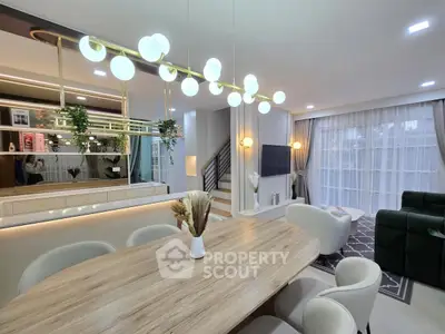 Luxurious modern living room with elegant dining area and stylish lighting, perfect for entertaining.