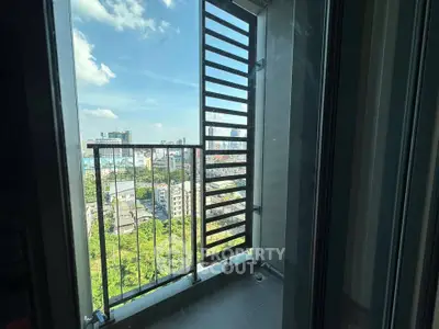 Stunning city view from a modern high-rise balcony with sleek railing design.