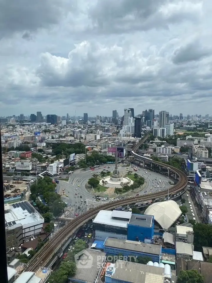 Stunning cityscape view from high-rise building overlooking bustling urban landscape and iconic roundabout.