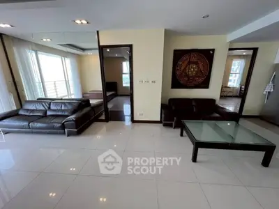 Spacious modern living room with leather sofas and glass coffee table