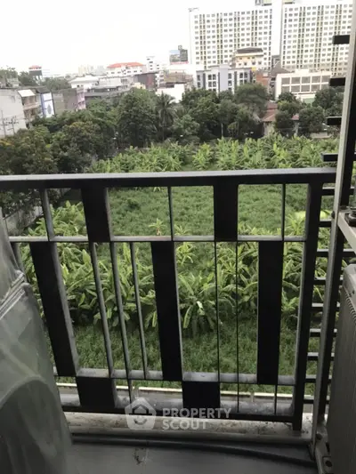 Urban balcony with lush green view and cityscape backdrop