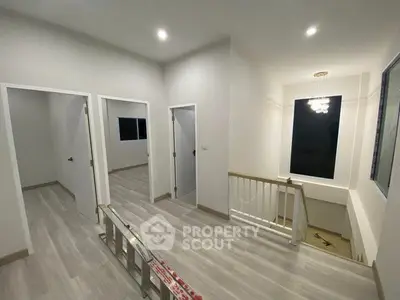 Modern hallway with sleek flooring and bright lighting in a contemporary home.